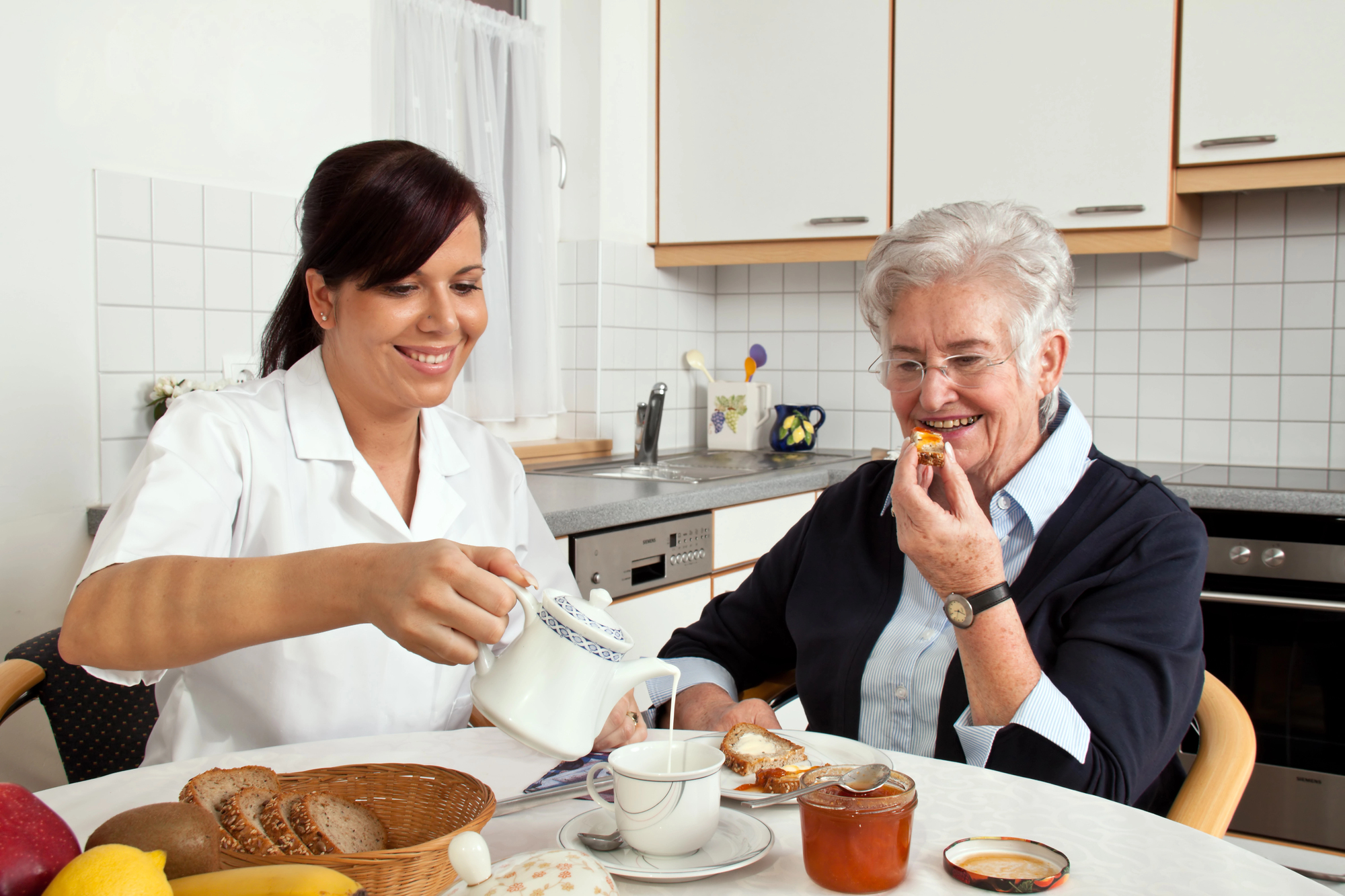 Caregiver helping elderly person with daily tasks