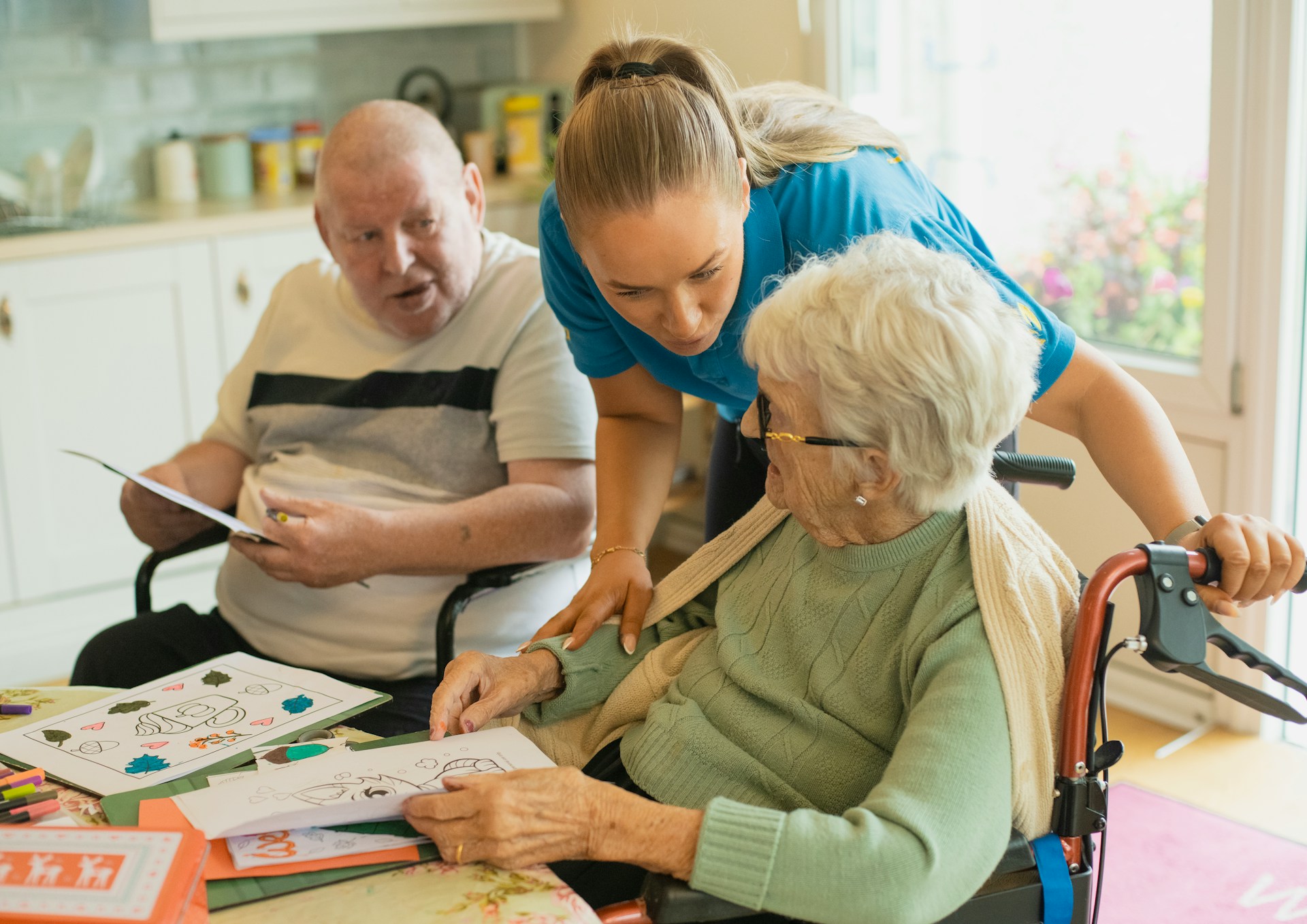 Caregiver attending to elderly couple in their home