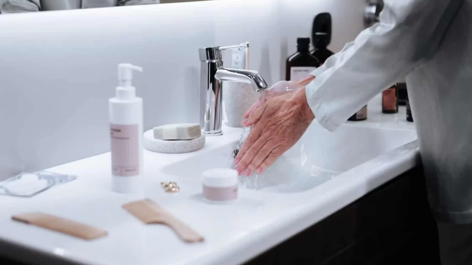 Close-up of an elderly person washing their hands